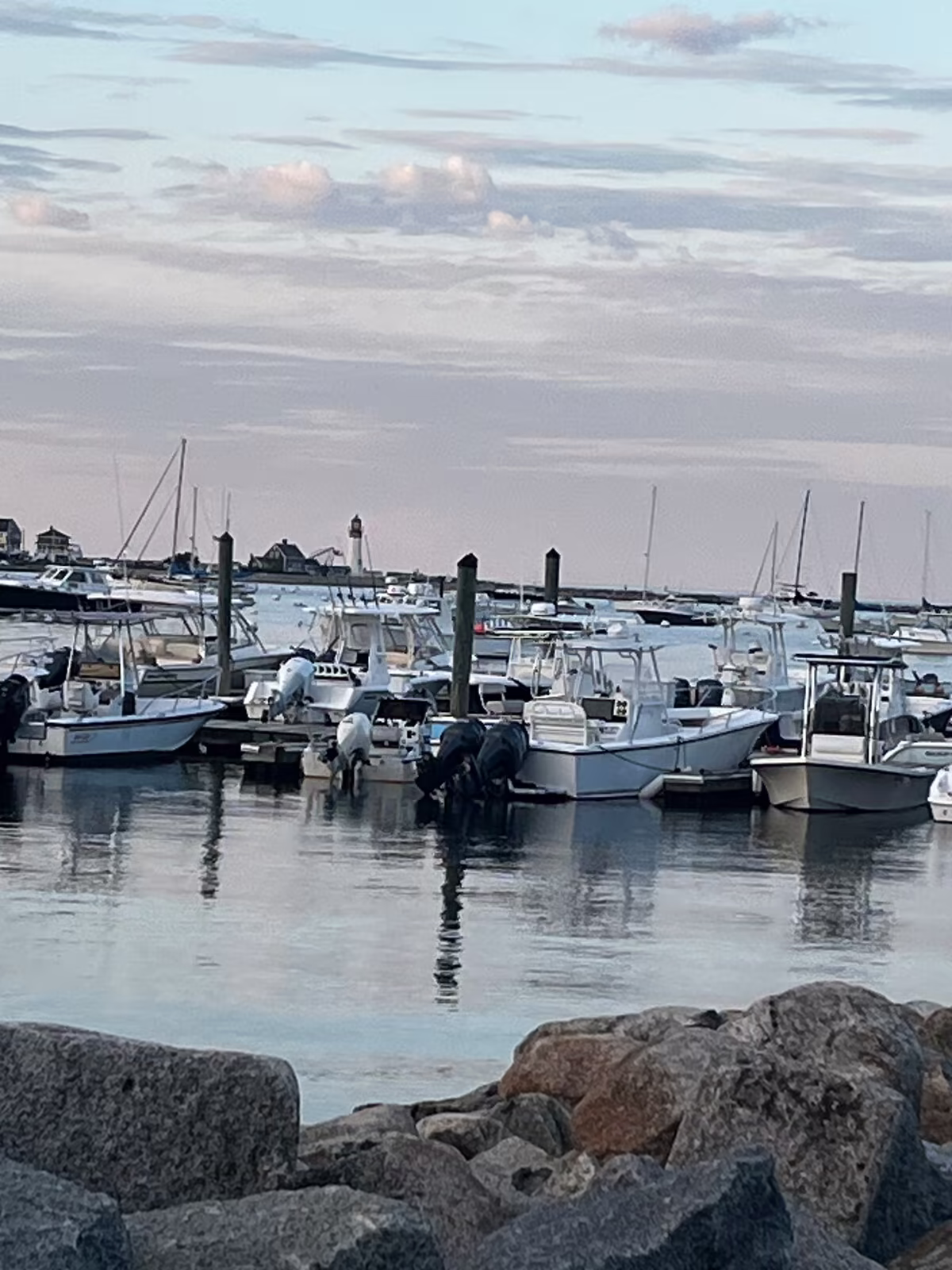 The harbor at dusk, reflections on still water under a pink sky